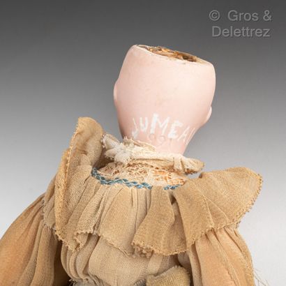 null Porcelain head doll wearing a crepe and lace dress and holding a cane. She wears...