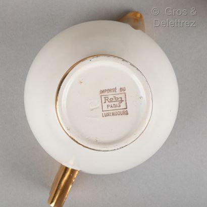 ROBJ White and gold porcelain tea set composed of a teapot, a milk pot, a sugar pot,...