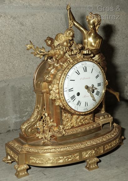 null Chased and gilt bronze clock representing Venus standing on a stool offering...