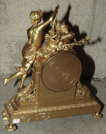 null Chased and gilt bronze clock representing Venus standing on a stool offering...