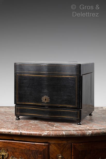 null Blackened wood veneer and brass fillets liquor cabinet. It opens with a flap...