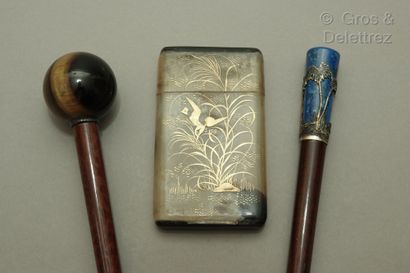 null 
Two mahogany umbrella handles, one with a spherical pommel in tiger's eye,...