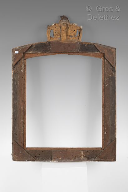 null A carved and gilded wood and stucco mirror frame decorated with foliage scrolls...