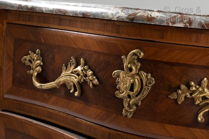 null A curved chest of drawers in plum veneer and native woods inlaid with leaves,...