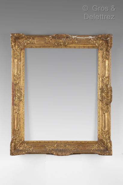 null Oak and gilded stucco frame decorated with shells in the corners and the middle.

Regency...