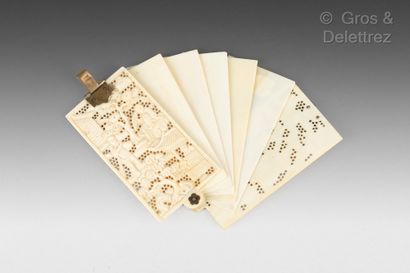 null Ivory fan card holder, with openwork decoration of characters among pine trees....