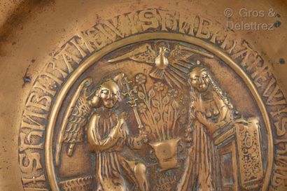 null A stamped, embossed and hallmarked brass offering dish depicting the Annunciation,...