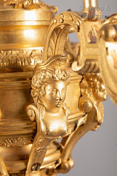 null A gilt bronze chandelier with a baluster shaft decorated with acanthus leaves,...