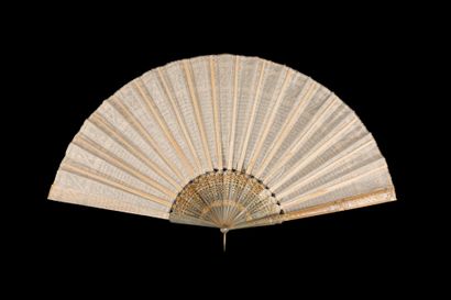  Mille paillettes, Europe, circa 1920 Folded fan, the leaf in cream silk embroidered...