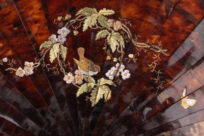null The bird and the butterfly, circa 1890
Brown tortoiseshell fan** engraved with...