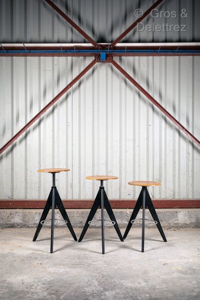 null Suite of three stools with compass legs in black lacquered metal.