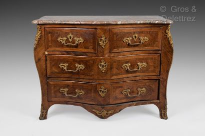 null 
A rosewood veneer curved COMMODE opening with four drawers on three rows, the...