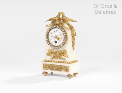 null White marble and gilt bronze clock topped with doves. Dial signed Sevres vase....