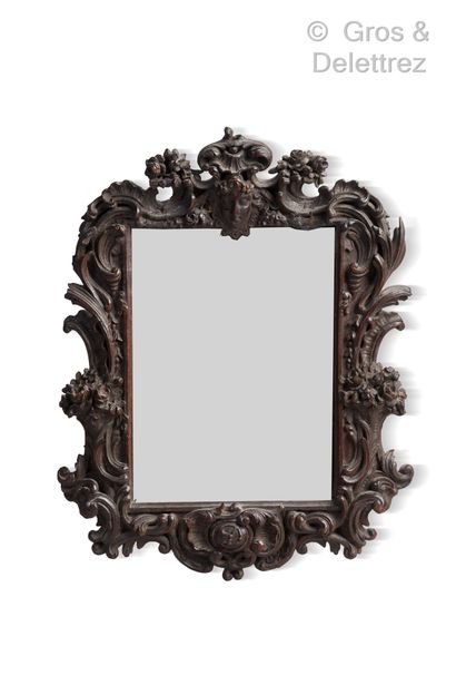 null Small mirror, the frame in dark wood molded, openwork and richly carved with...