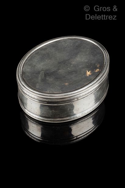 null Oval silver box decorated with pearls and laurels, the lid surmounted by a figure....