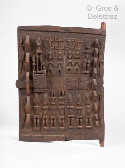 Dogon carved door decorated with characters...