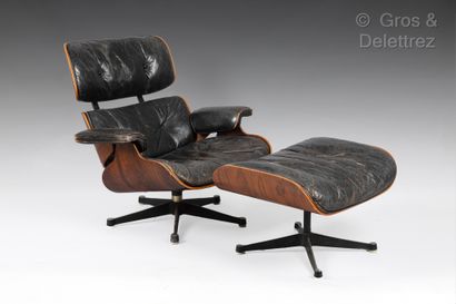  Charles and Ray EAMES Armchair and ottoman in rosewood veneer, trimmed with black...