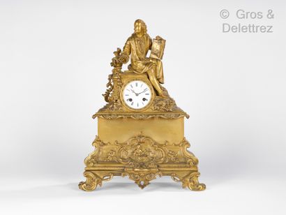 Gilded bronze clock featuring an artist seated...