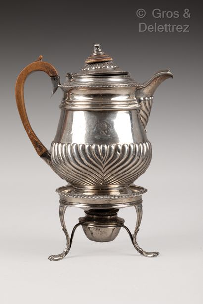 null A baluster-shaped silver coffee pot decorated with gadroons, it rests on a doucine...
