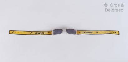 CHANEL Pair of sunglasses in white polished acetate, translucent rubber strap, black,...