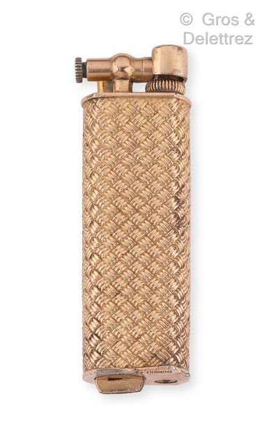 DUNHILL Lighter in pink gold plated metal, the body decorated with a braid. Height...