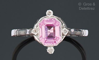 White gold ring set with a pink stone and...