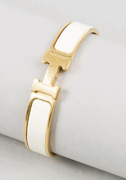 HERMES Paris made in France Bracelet jonc en métal doré et émail ivoire, fermoir...