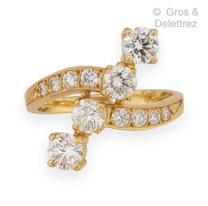 null Yellow gold ring set with a line of four brilliant-cut diamonds surrounded by...