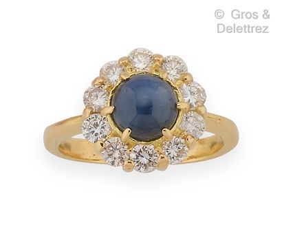 null Yellow gold "Flower" ring, set with a cabochon sapphire in a circle of brilliant-cut...