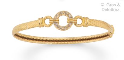 null Twisted yellow gold "Jonc" bracelet, centered on two gadrooned attachments holding...