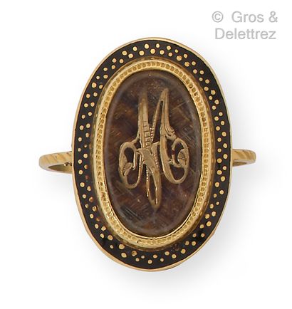 null Yellow gold ring, decorated with a number on braided hair in a black enamel...