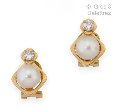 null Pair of yellow gold ear clips, each adorned with a cultured pearl topped by...