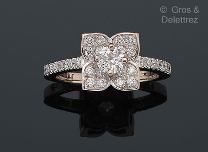 null White gold "Flower" ring, set with a brilliant-cut diamond in a circle of smaller...