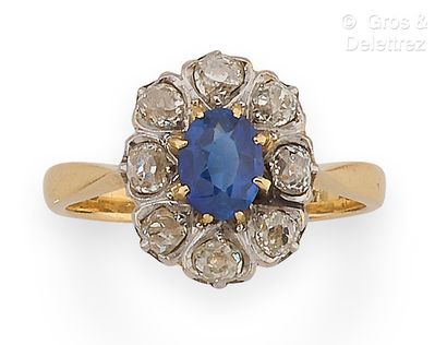 null Yellow gold "Flower" ring, set with a sapphire in a circle of old-cut diamonds....