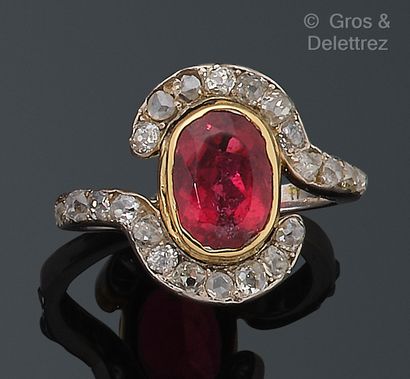 null Platinum and yellow gold ring, set with a red tourmaline in a circle of old-cut...