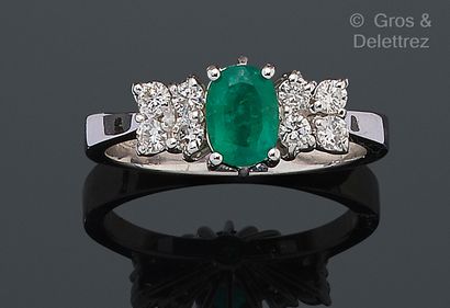 null White gold "Garter" ring, set with an oval emerald and two square motifs each...