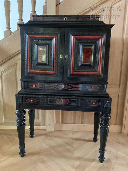 null Cabinet in blackened wood, red decaille veneer and brass fillets opening with...
