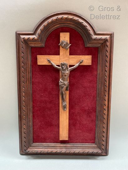 null Crucifix in patinated bronze regula presented in a wooden frame carved with...