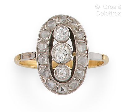 Yellow gold and platinum ring, set with three...