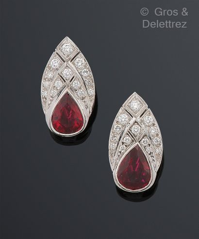 null Pair of white gold and platinum ear clips, adorned with a red stone and a pear-shaped...