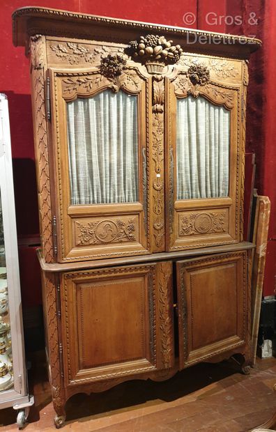 null (SD) Two bodies china cabinet in natural oak richly carved with a fruit basket,...
