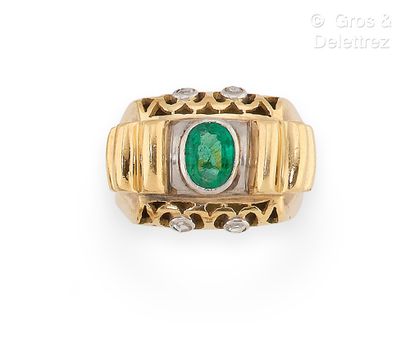 null Yellow gold ring with a Godronné design, set with an oval emerald surrounded...