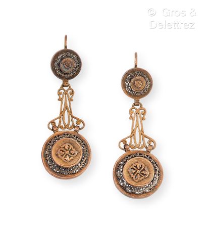 null Pair of yellow gold and silver earrings, composed of circular plates with openwork...