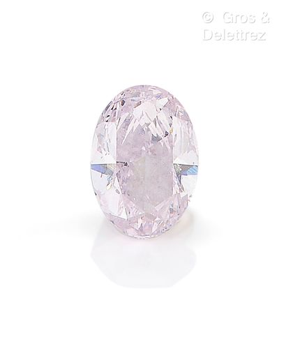 Oval cut colored diamond on paper weighing:...