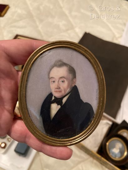 null Miniature 
CARUSON
Portrait of a man with a blue frock coat and a black bow,...