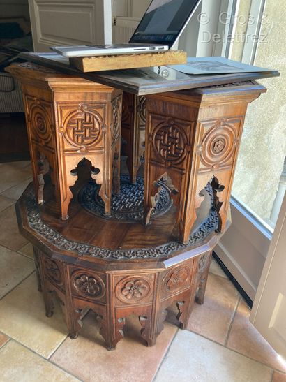 null Table and three stools in molded wood and carved with flowers.
Middle East
