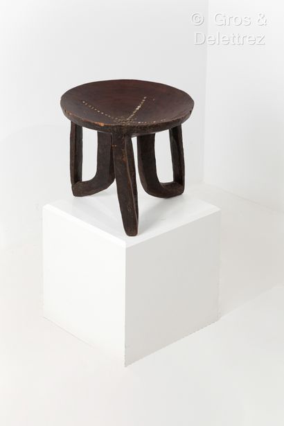 null Tripod stool.
Gorague people, Ethiopia.
Patinated wood, hollow seat studded...