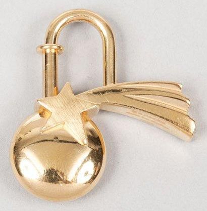 HERMÈS Paris made in France Porte clefs figurant une étoile filante en métal dor...