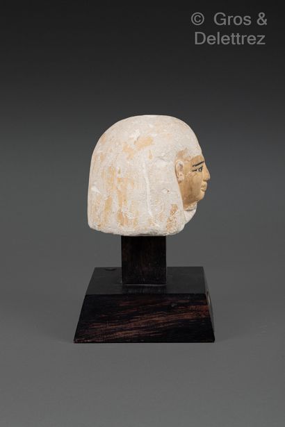 null Canopic vase stopper with anthropomorphic head. The skin is yellow. He wears...