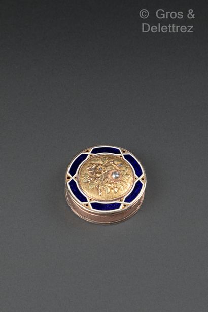 null Set of three circular boxes, the first in 9K gold, the blue enameled lid surrounding...